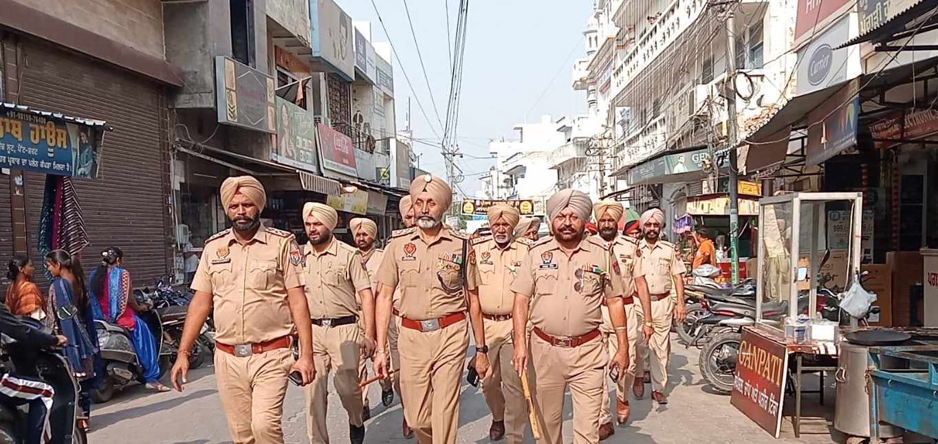 Shahkot police hold flag march for peaceful festive season.